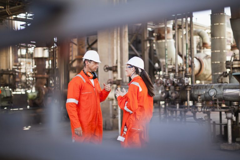 Workers Talking At Oil Refinery